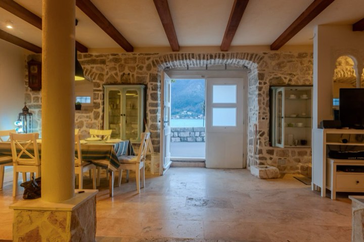 The communal lounge room, with doors open to the water