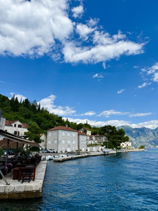 The Perast waterfront under blue sky